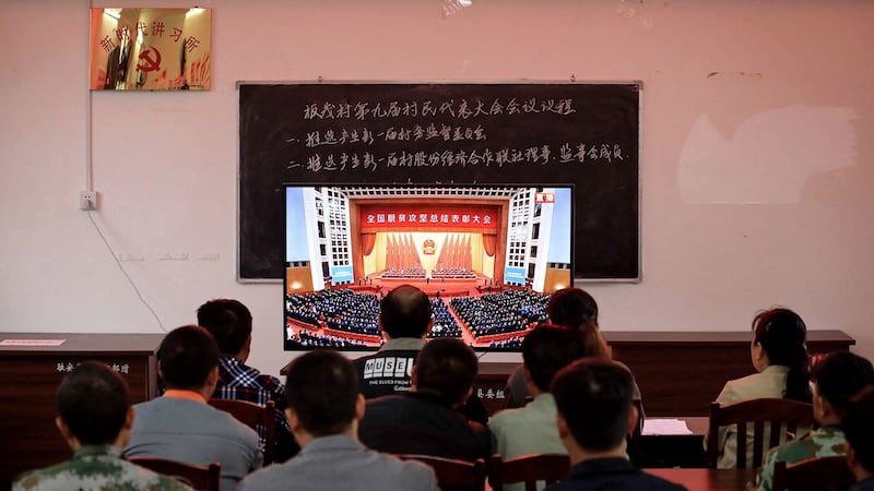 2021年2月25日,新时代讲习所人员观看中国全国脱贫攻坚总结表彰大会。(法新社)