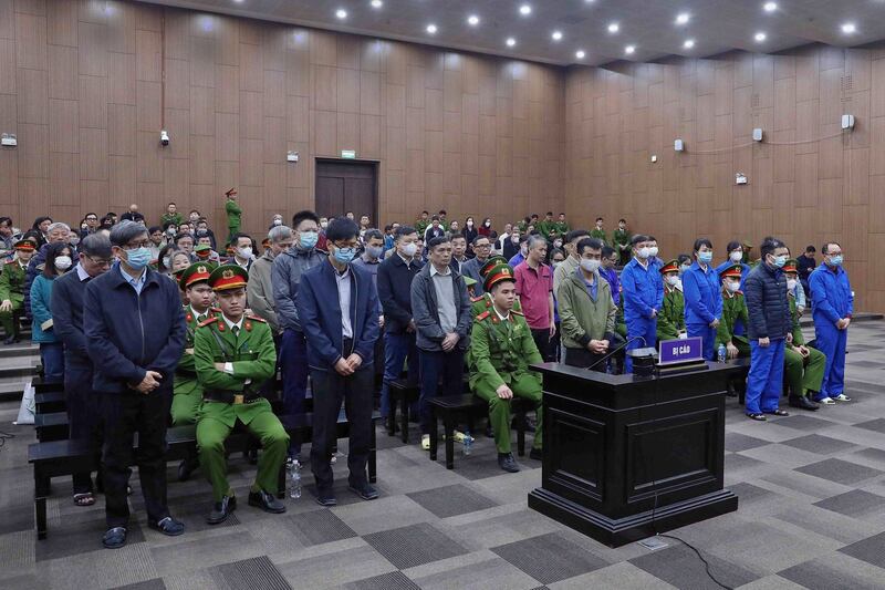 Thirty-eight defendants, including a former health minister stand in a courtroom during an anti-corruption trial in Hanoi, Jan. 3, 2024. (Vietnam News Agency via AFP)