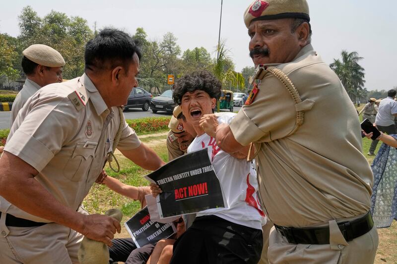 Policemen detain exiled Tibetans protesting against the death of Tulku Hungkar Dorje, a revered Tibetan religious leader, while in custody in Vietnam, outside Chinese embassy in New Delhi, India, April 11, 2025.