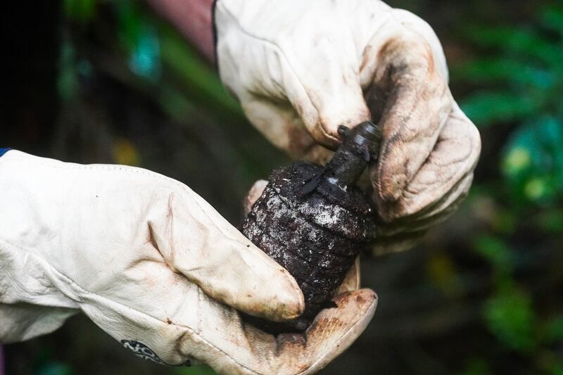 Roger Hess, a member of the mine action group Norwegian People’s Aid, holds a Type 91 grenade used by the Japanese military during WWII on the island of Peleliu, Palau, Nov. 26, 2024.