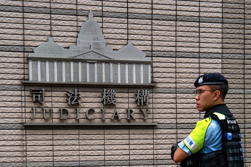 A police officer stands outside the West Kowloon court where jailed Hong Kong media mogul Jimmy Lai's national security trial is taking place in Hong Kong on Aug. 28, 2025.
