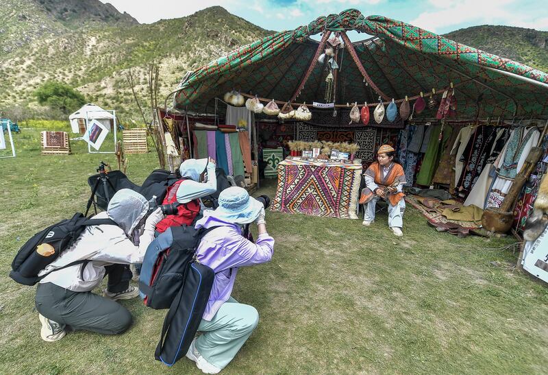 Tourists take photos at the Nomadic Culture Tourism Festival on June 15, 2024 in Urumqi,  Xinjiang Uyghur Autonomous Region of China.