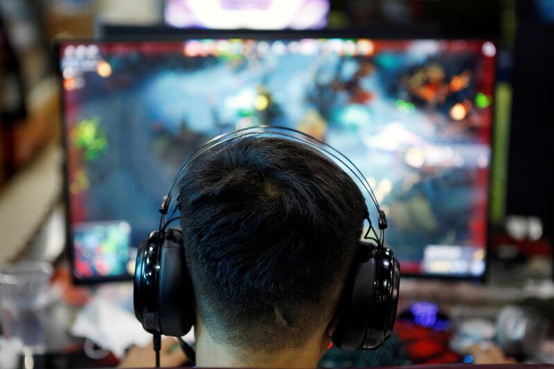 A man plays an online game at an internet cafe in Beijing, Aug. 31, 2021.