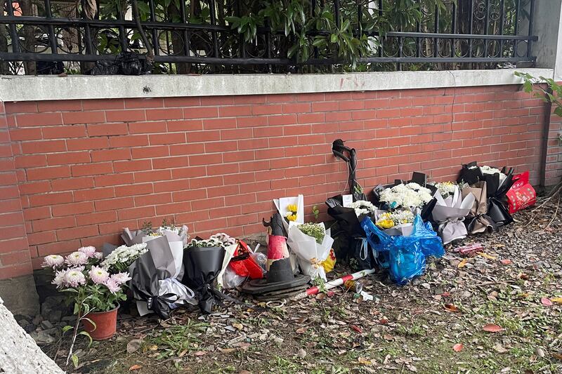 Floral tributes are placed near an entrance to the Wuxi Vocational College of Arts and Technology following a knife attack, in Wuxi, Jiangsu province, China Nov. 17, 2024. (Reuters/Brenda Goh)