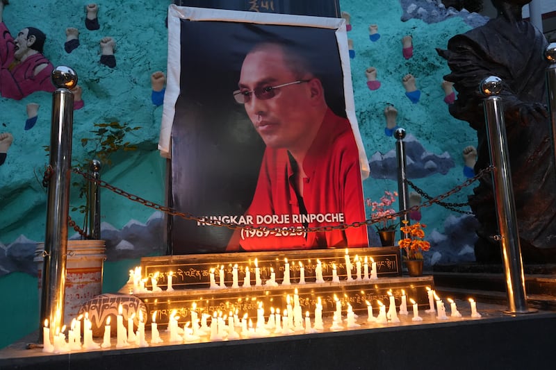 Devotees of revered Tibetan Buddhist monk Tulku Hungkar Dorjee take part in a candlelight vigil in Dharamsala, India, April 11, 2025.