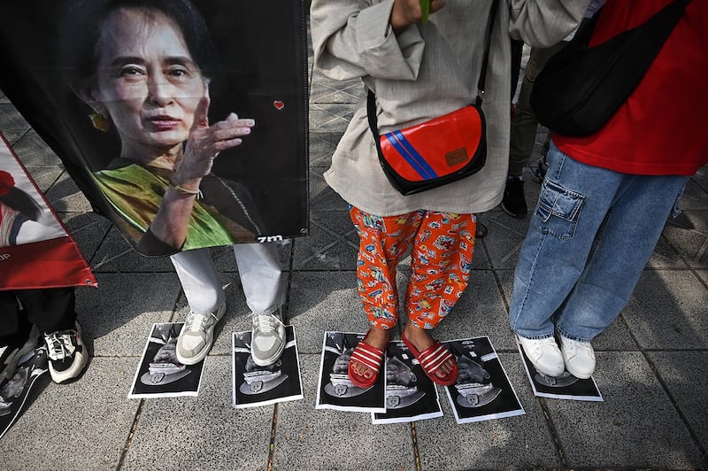Protesters step on images of Myanmar junta leader Senior Gen. Min Aung Hlaing during a demonstration outside the UN office in Bangkok on Feb. 1, 2024, to mark the third anniversary of the coup in Myanmar. (Lillian Suwanrumpha/AFP)