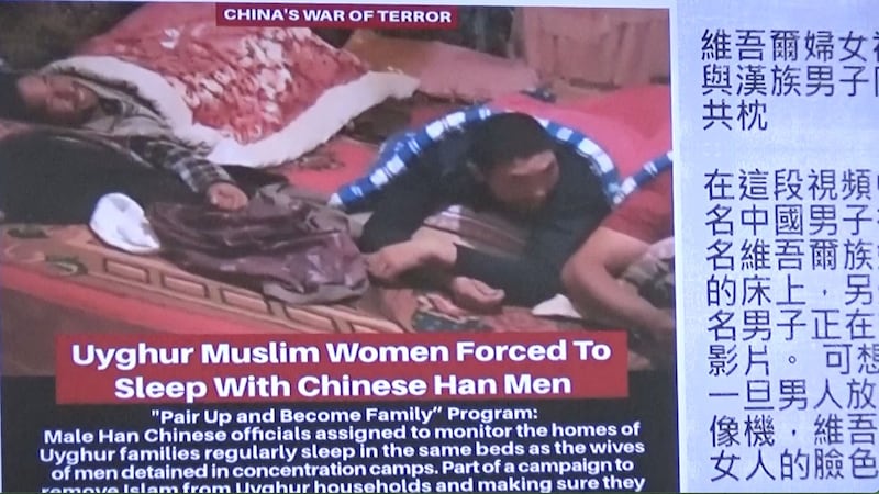 “维吾尔运动”组织创办人茹仙·阿巴斯控在台湾立法院记者会上播放视频,指三名汉族男性和一名维吾尔女性在一张床上,其中一人还在录影。(阿巴斯提供、记者夏小华翻摄)