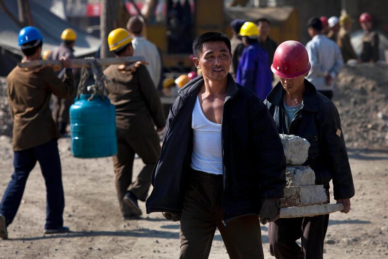 In this Oct. 11, 2011, photo, North Korean construction workers carry material in the Mansudae area of Pyongyang, North Korea.
