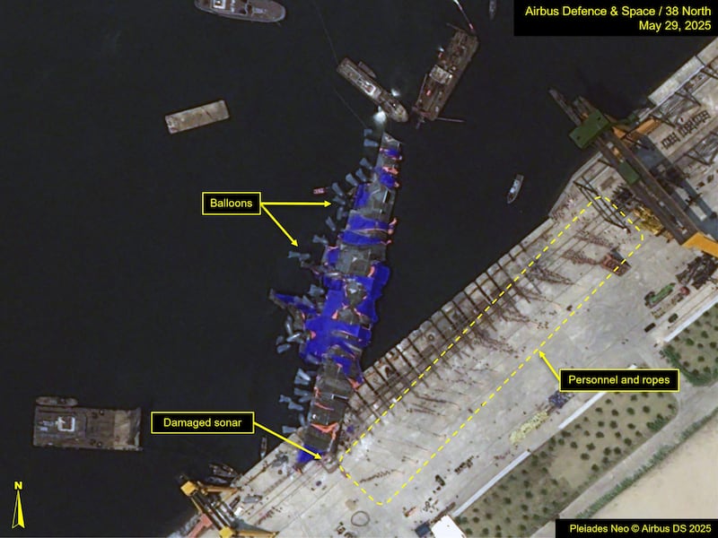 This May 29, 2025, image released by 38North.org, shows balloons and personnel utilized to lift the capsized North Korean destroyer back upright.
