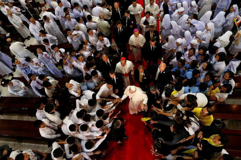Devotees greet Pope Francis as he visits St. Peter's Parish church in the Sam Phran district of Nakhon Pathom Province, Nov. 22, 2019.