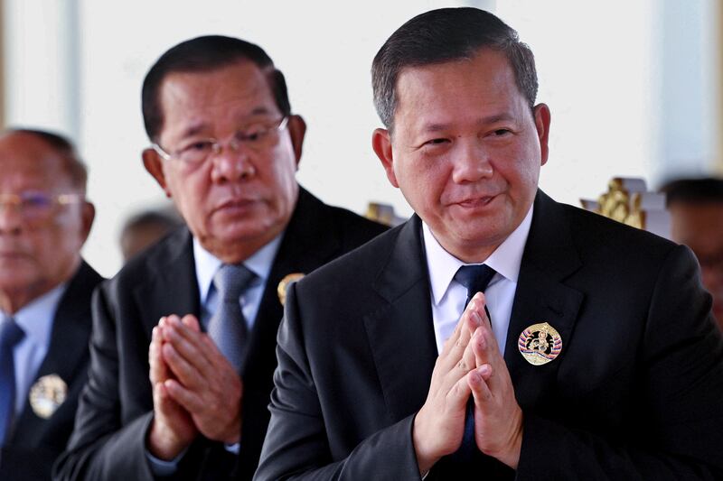 President of the Senate Hun Sen, left, and Cambodia's Prime Minister Hun Manet, right, during a ceremony marking the 74th founding anniversary of the Cambodian People's Party (CPP) in Phnom Penh on June 28, 2025.