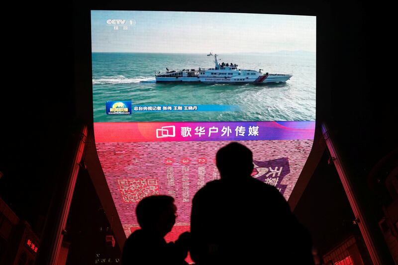 A giant screen shows news footage of military drills conducted in the Taiwan Strait and areas to the north, south and east of Taiwan, by the Eastern Theatre Command of the Chinese People's Liberation Army (PLA), in Beijing, China October 14, 2024. REUTERS/Tingshu Wang